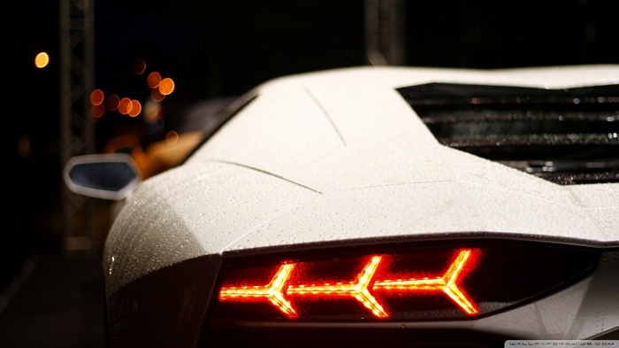 White Lamborghini Aventador taillight at night
