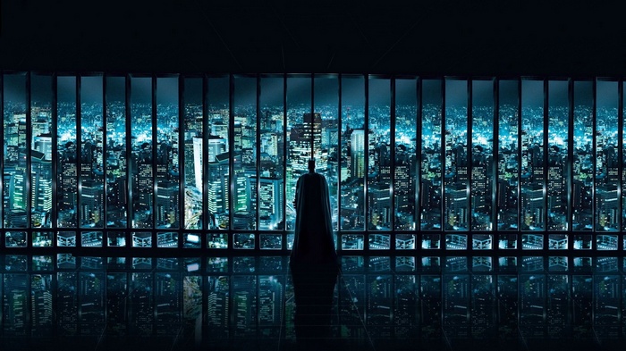 Batman overlooking Gotham City at night