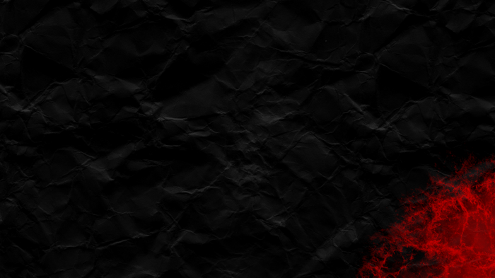 Abstract crumpled black paper with red texture