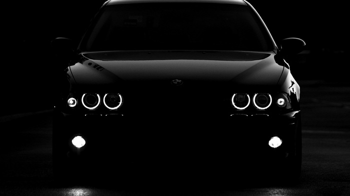 Black BMW E39 car with angel eyes headlights