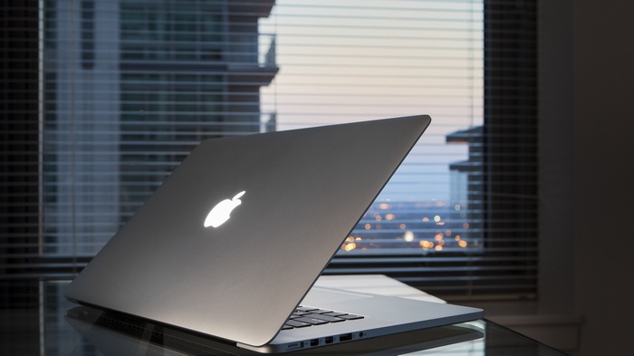 Apple MacBook laptop with glowing logo