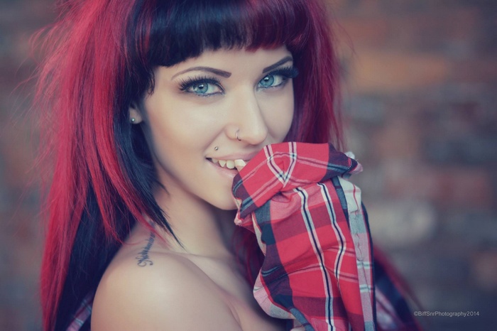 Emma Howes with red and black hair and nose rings