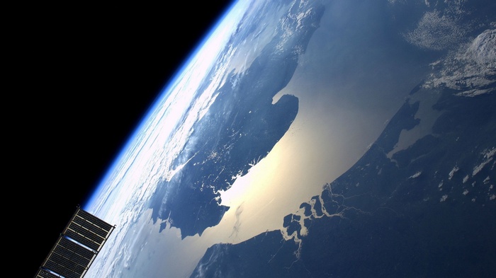 Earth from space with a satellite panel