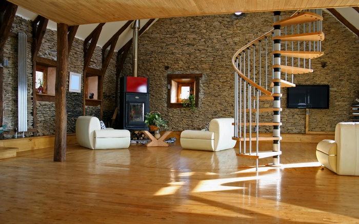 Interior design with wooden stairs and stone wall