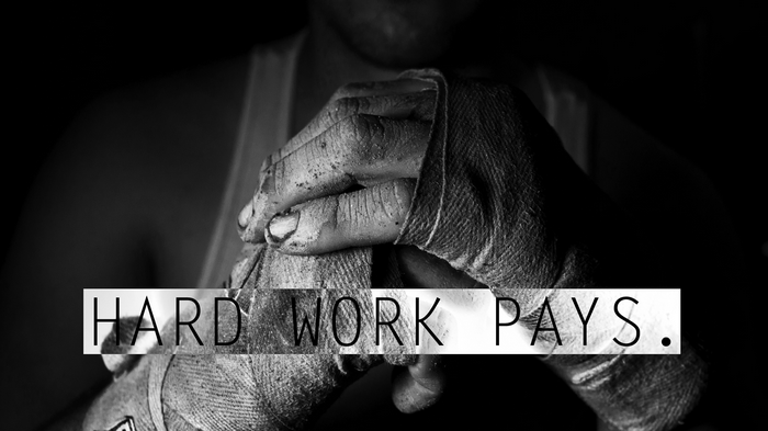 Monochrome image of hands wrapped for boxing with text "HARD WORK PAYS."