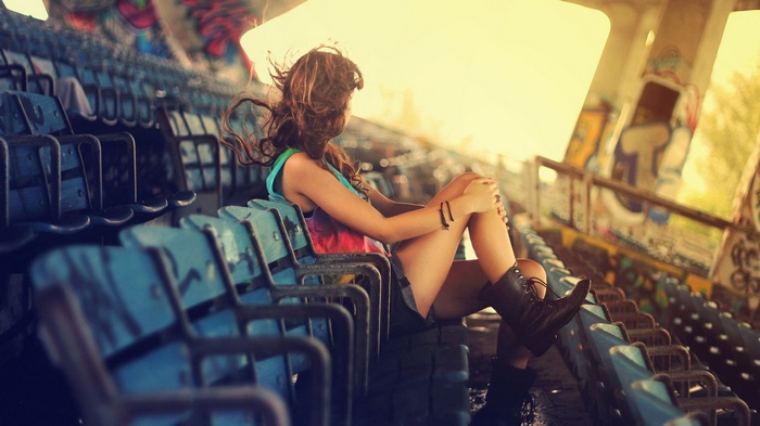 Woman with long hair sitting in stadium seats
