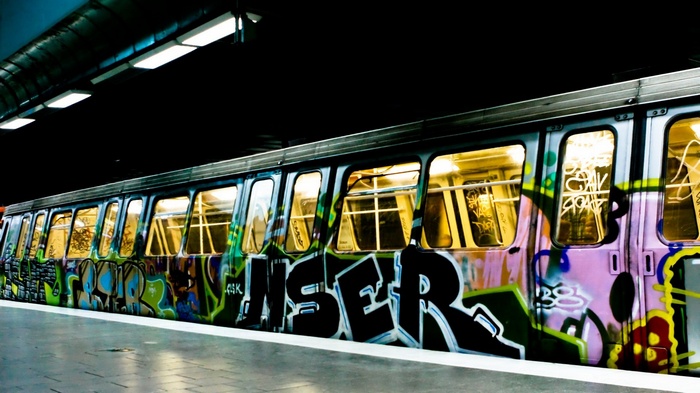 Graffiti-covered subway train at a station