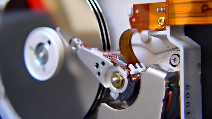Close-up of a hard drive read/write head and platter