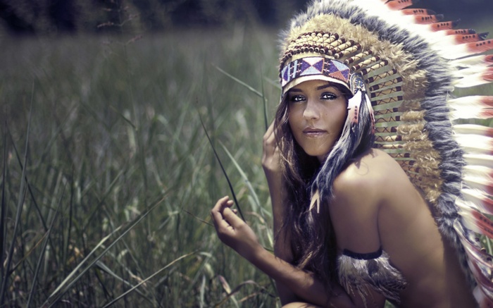 Woman with Native American Headdress in a Field