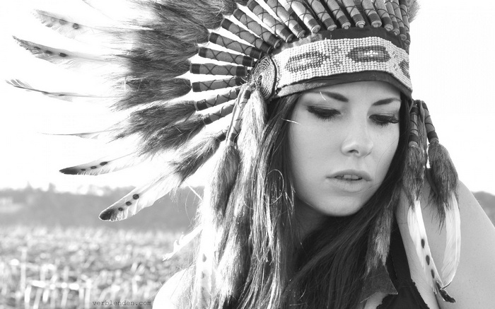 Woman wearing a Native American headdress with feathers