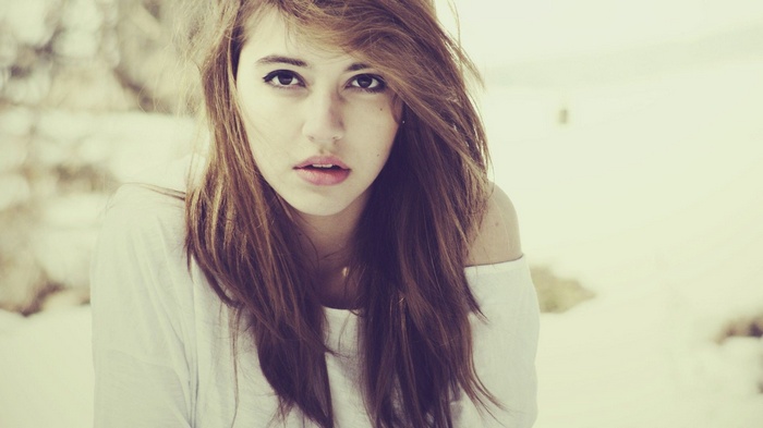 Woman with long brown hair looking at viewer