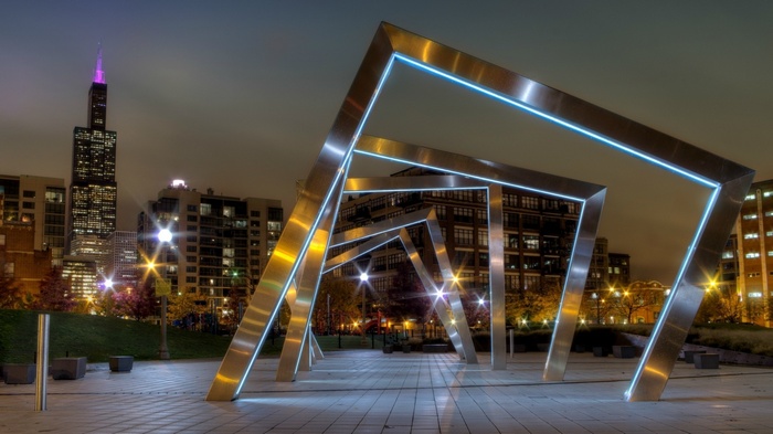 Chicago cityscape at night with modern metal sculpture