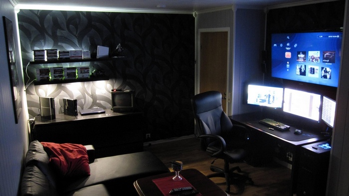 Gaming room with multiple monitors and couch