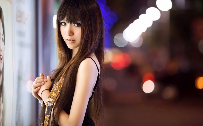 Asian woman with long brown hair looking at viewer