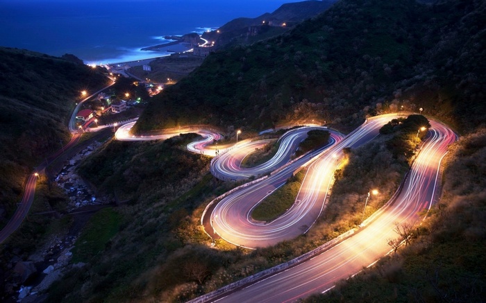 Long exposure of a winding mountain road at night