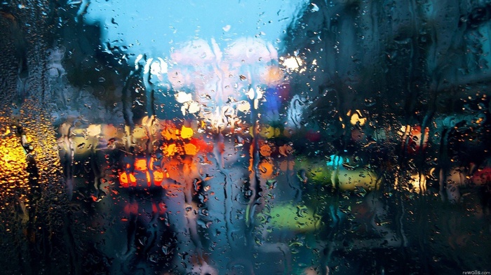 Rain on glass with city lights bokeh