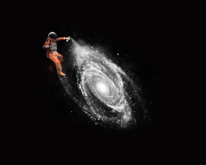 Astronaut spraying a galaxy with paint
