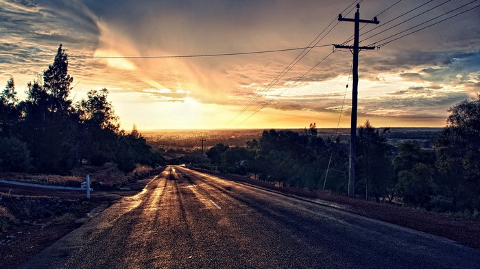 Road with power lines at sunset with HDR effect