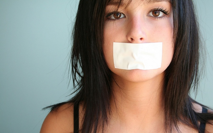Woman with tape over her mouth