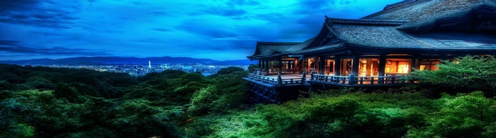 Asian architecture overlooking a cityscape at dusk