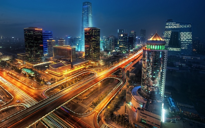 China night cityscape with traffic interchange and skyscrapers