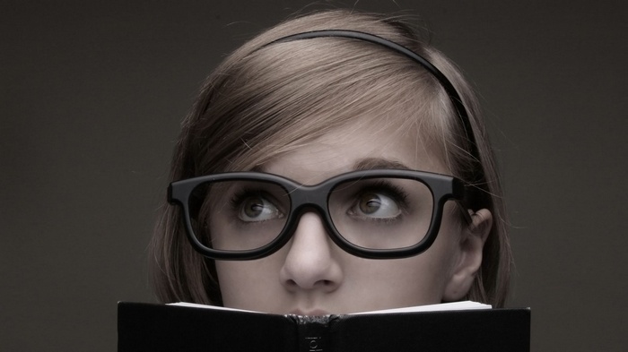 Woman with glasses reading a book