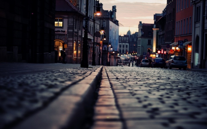 Cobblestone street in a European city at dusk