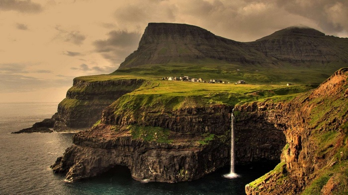 Waterfall cascading from cliffs in Gasadalur, Faroe Islands