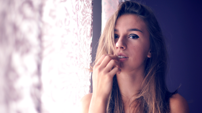 Woman with long brown hair and makeup