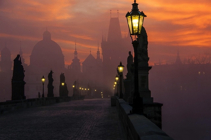 Charles Bridge in Prague at sunrise with fog