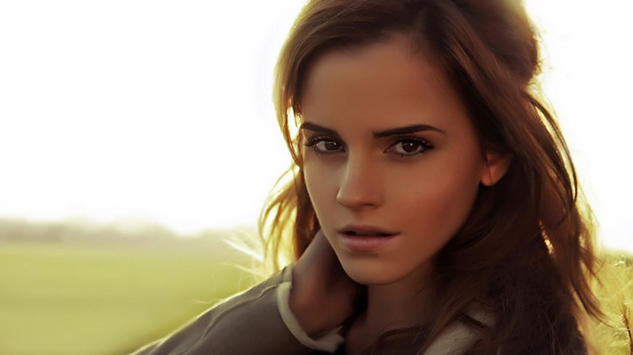 Emma Watson looking at the viewer outdoors