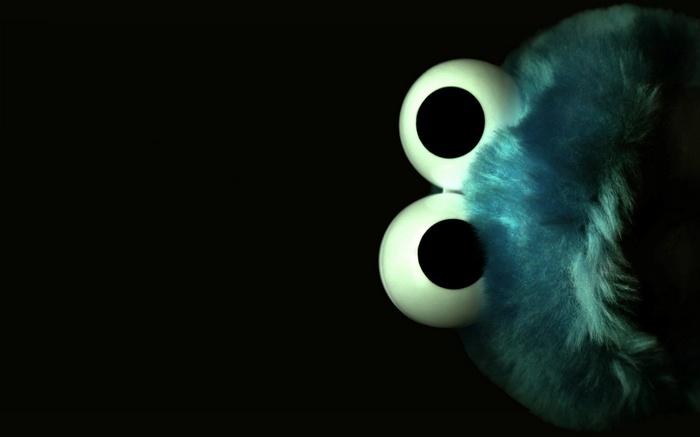 Cookie Monster with large eyes on black background
