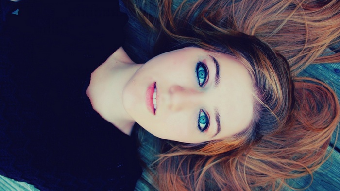 Young woman with blue eyes lying down