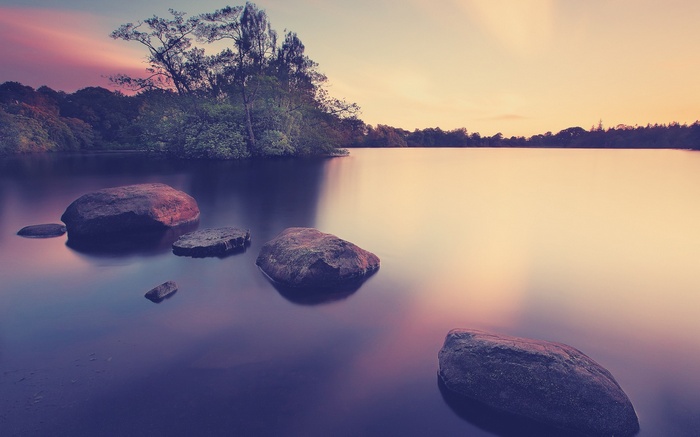Rocks in a lake during long exposure sunset