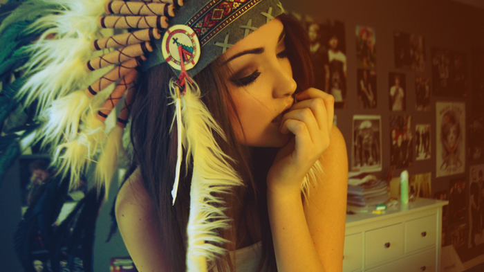 Melanie Iglesias wearing a Native American headdress