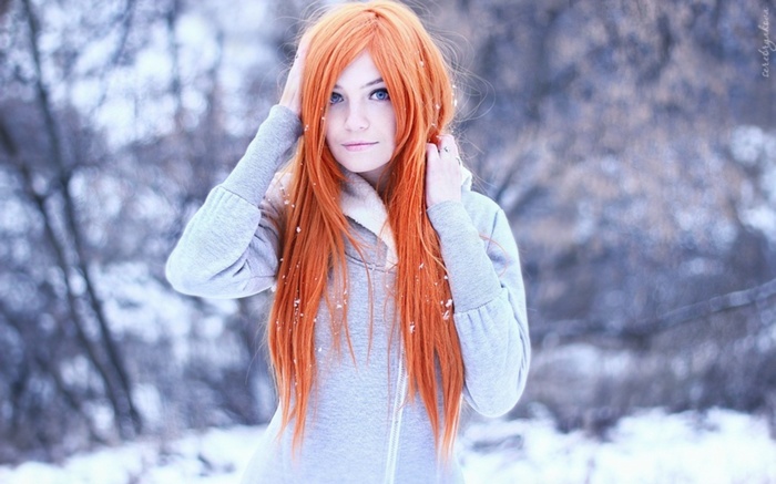 Woman with long orange hair in the snow