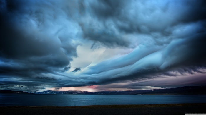 Dramatic storm clouds over a body of water