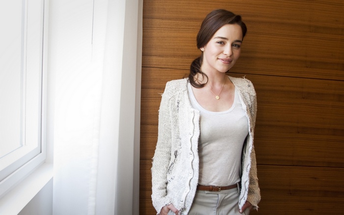 Emilia Clarke wearing a white top and cardigan