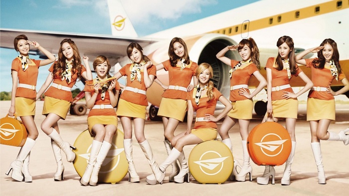 Girls' Generation flight attendants posing with luggage