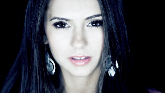 Nina Dobrev with dark hair and makeup