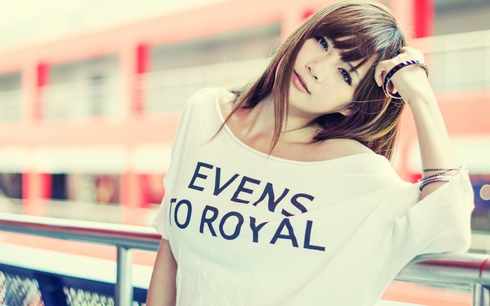 Asian woman with bangs wearing a white t-shirt