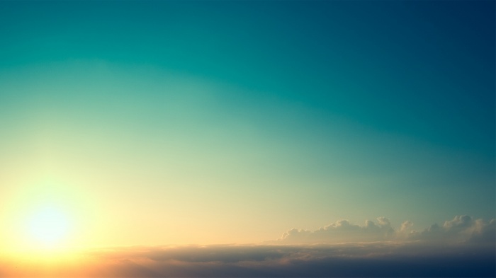 Sunlight over clouds at sunset