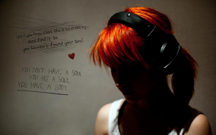 Redhead woman with headphones and text