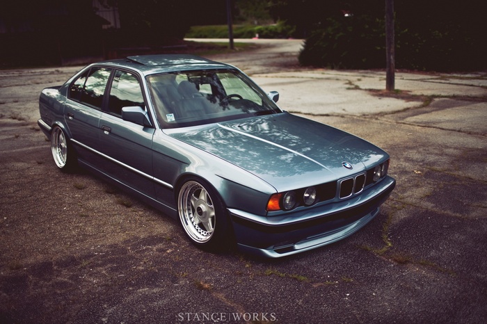 BMW E34 sedan parked on asphalt
