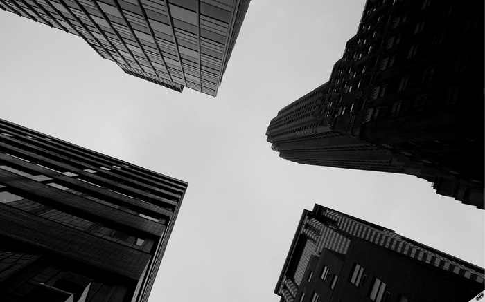Low angle view of four skyscrapers against a clear sky