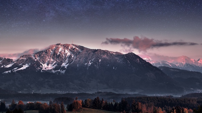 Snow-capped mountains under a starry sky
