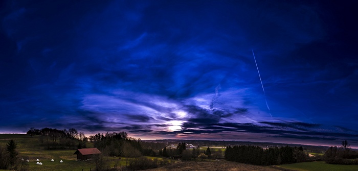 Panoramic sunset over a rural landscape with clouds