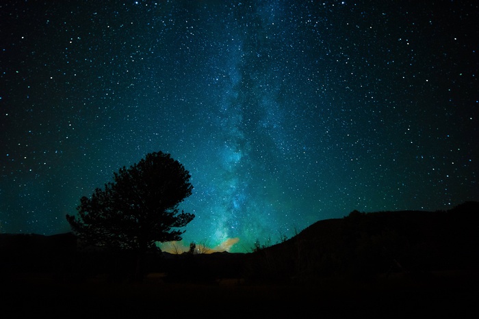 Milky Way galaxy over a silhouetted landscape