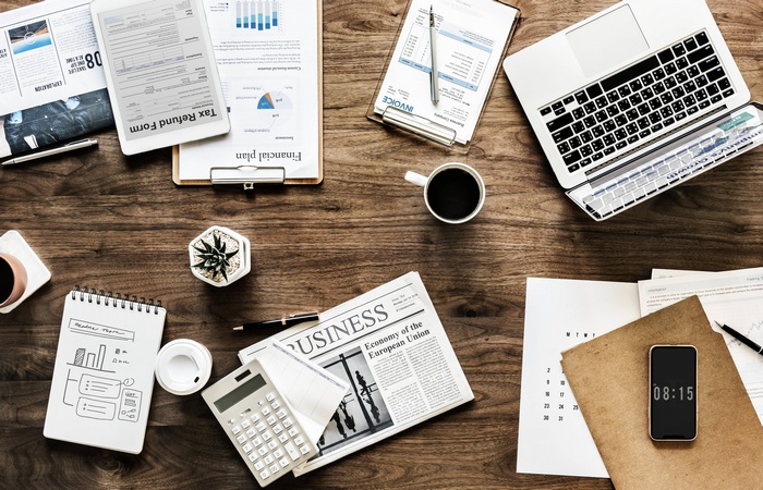 Business and finance documents on a wooden desk