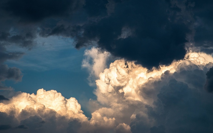 Dramatic storm clouds illuminated by sunlight